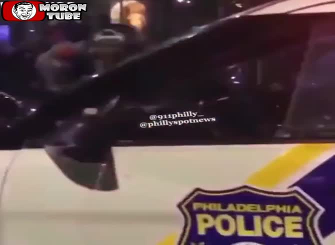 Video :In front of Philadelphia City Hall, a crazed mob leaps upon a police vehicle and does stunts